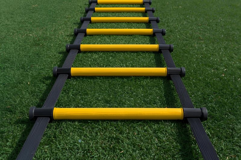 Sports equipment agility ladder set up on a grass field