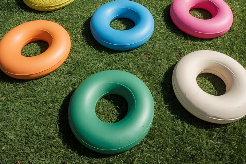 Sports equipment coloured quoits set out on a grass field