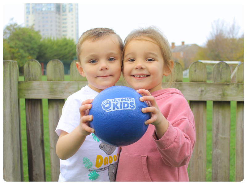 Children playing with an Ultimate Kids ball outdoors