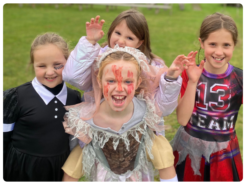 Children smiling and waving at an Ultimate Kids camp